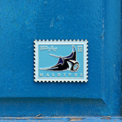 Stylized postage stamp design of a manta ray on a blue background